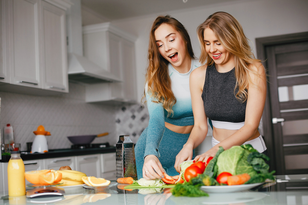  two-sports-girl-kitchen-with-veg